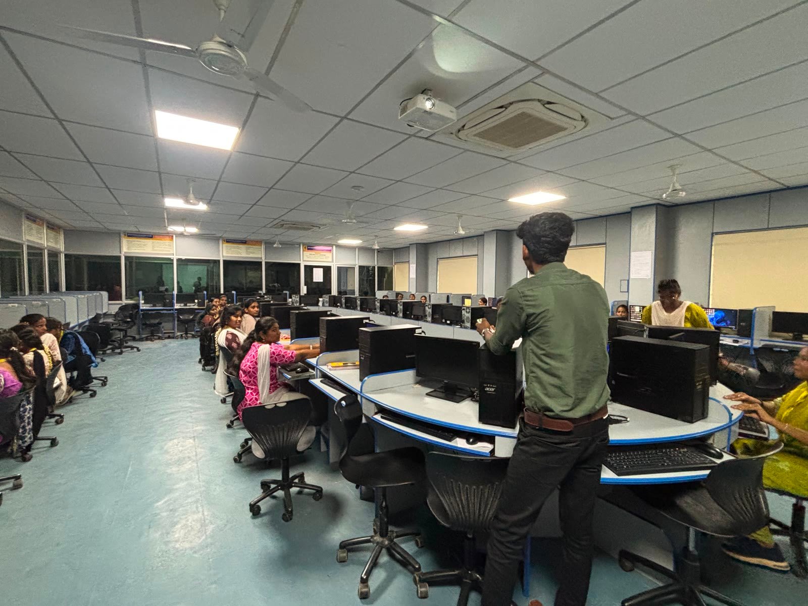 Trainer leading a C programming lab session at Muthayammal Engineering College